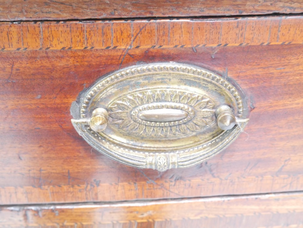 A Georgian mahogany sideboard featuring marquetry fan inlays, oval veneer door panels, a central drawer, and square tapered legs. View XI