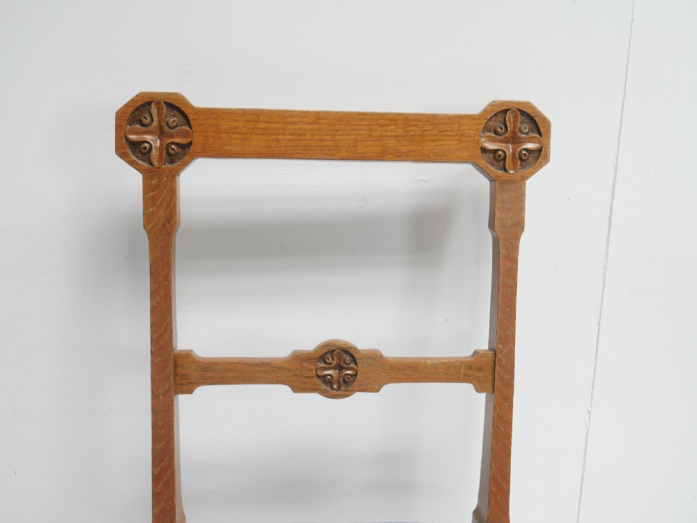 A set of twelve carved oak dining chairs with blue fabric upholstered seats and turned front legs. View IV
