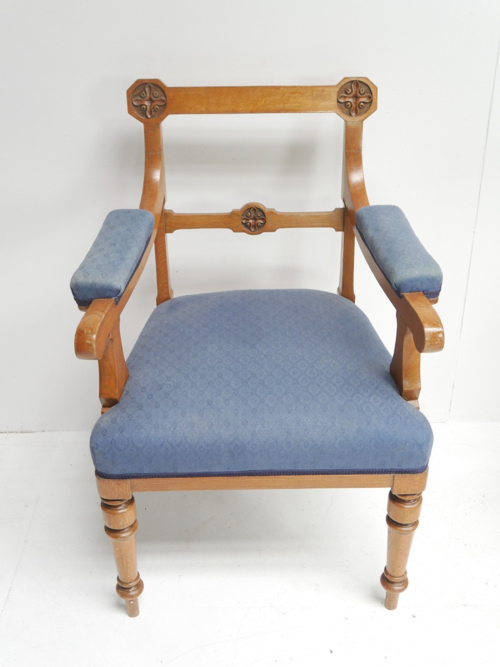 A set of twelve carved oak dining chairs with blue fabric upholstered seats and turned front legs. View V