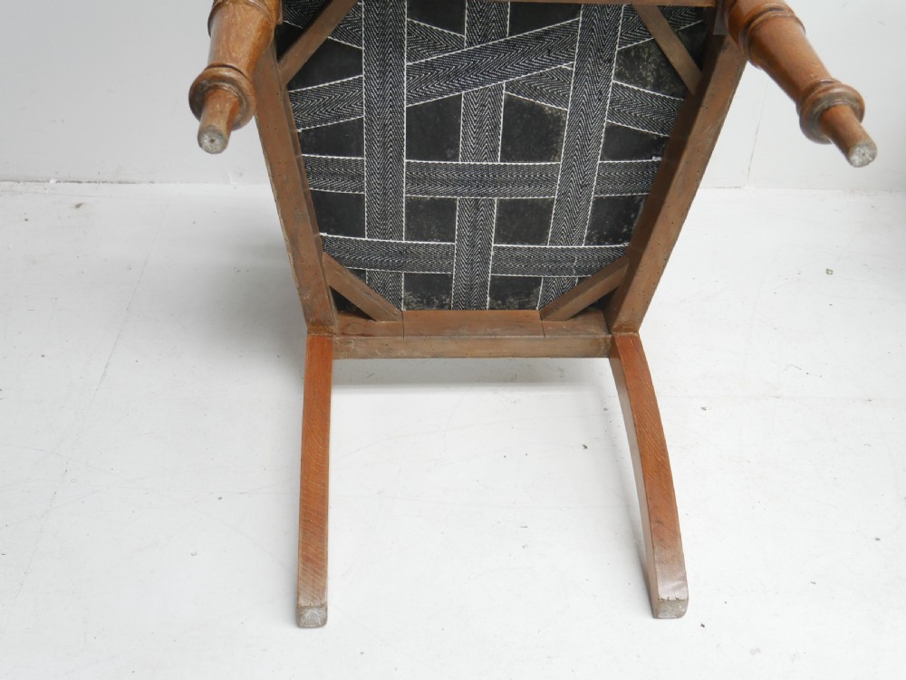 A set of twelve carved oak dining chairs with blue fabric upholstered seats and turned front legs. View XI