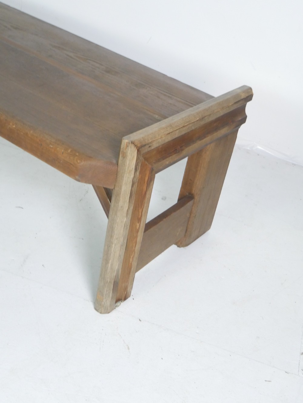 A long, rustic solid pine bench featuring raised side panels and sturdy central support legs. View II