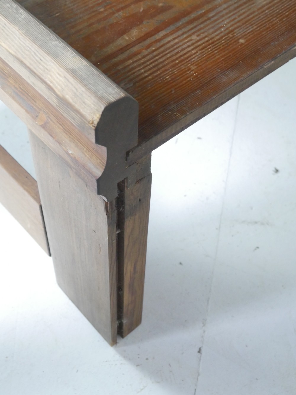 A long, rustic solid pine bench featuring raised side panels and sturdy central support legs. View III