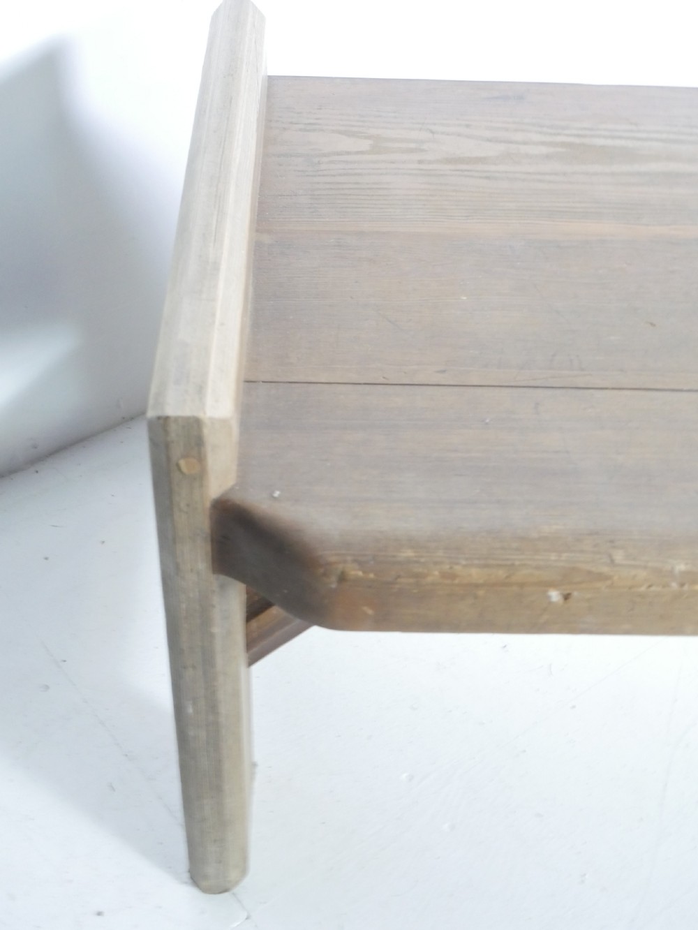 A long, rustic solid pine bench featuring raised side panels and sturdy central support legs. View VI