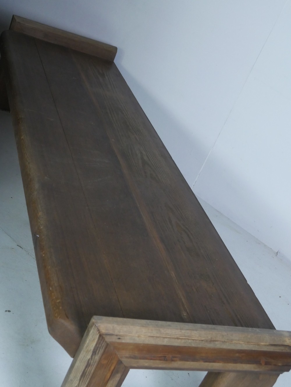 A long, rustic solid pine bench featuring raised side panels and sturdy central support legs. View VIII