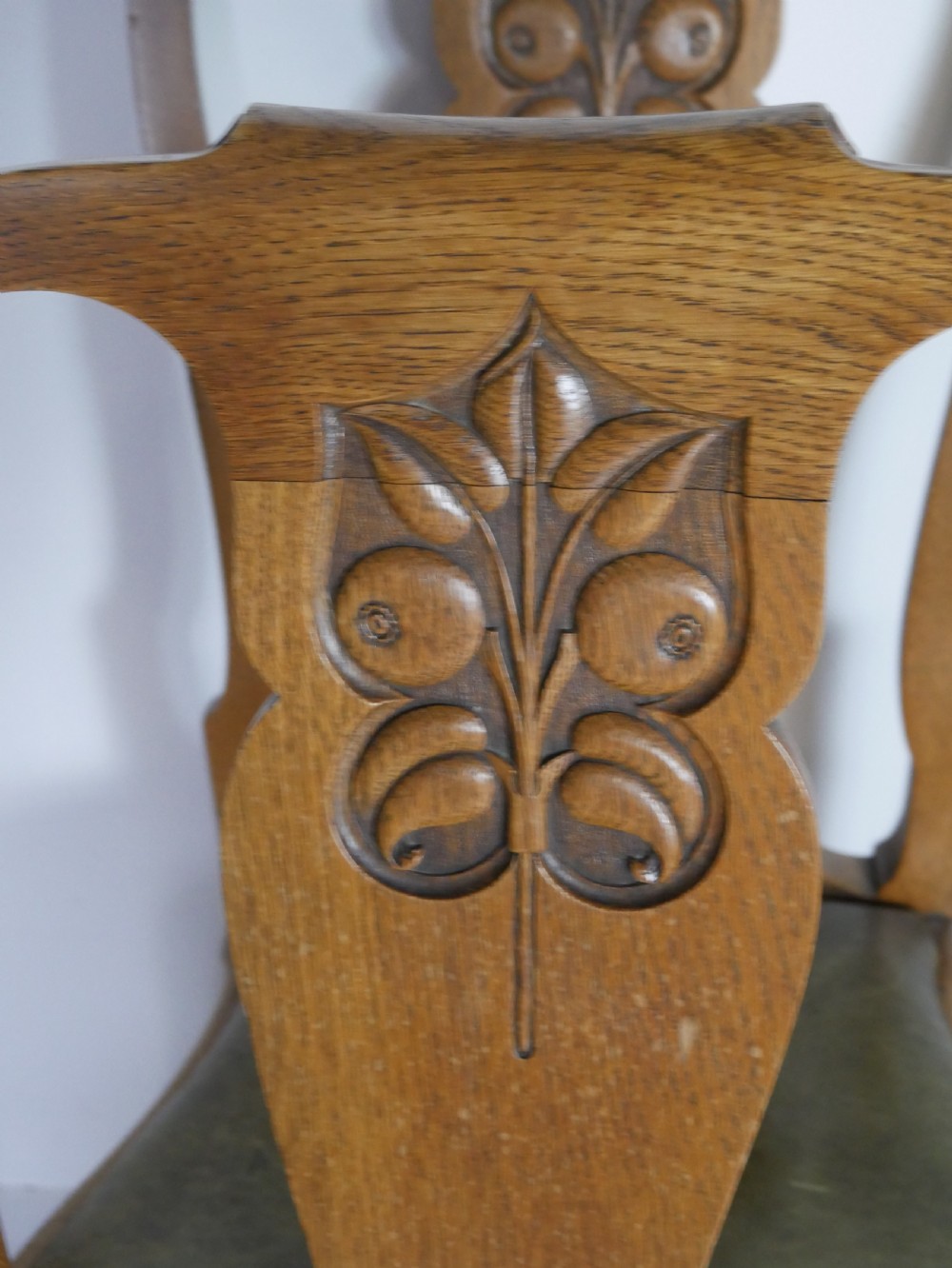 A large set of fourteen carved oak dining chairs featuring shaped back splats, drop-in upholstered seats, and cabriole front legs. View IX
