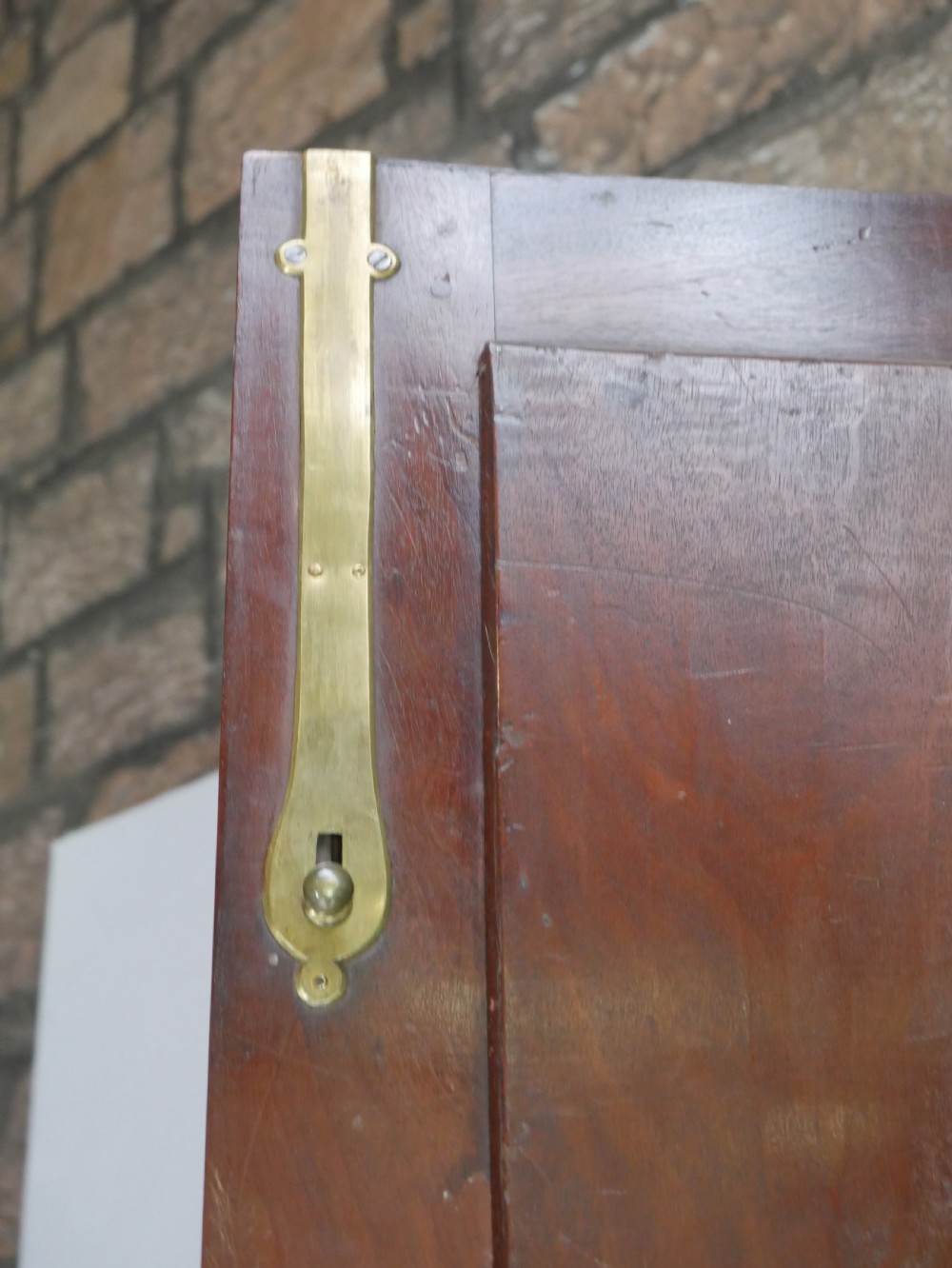 A tall Georgian mahogany bureau bookcase featuring a swan-neck pediment, glazed upper doors, a slant-front writing slope, four long drawers, and bracket feet. View V
