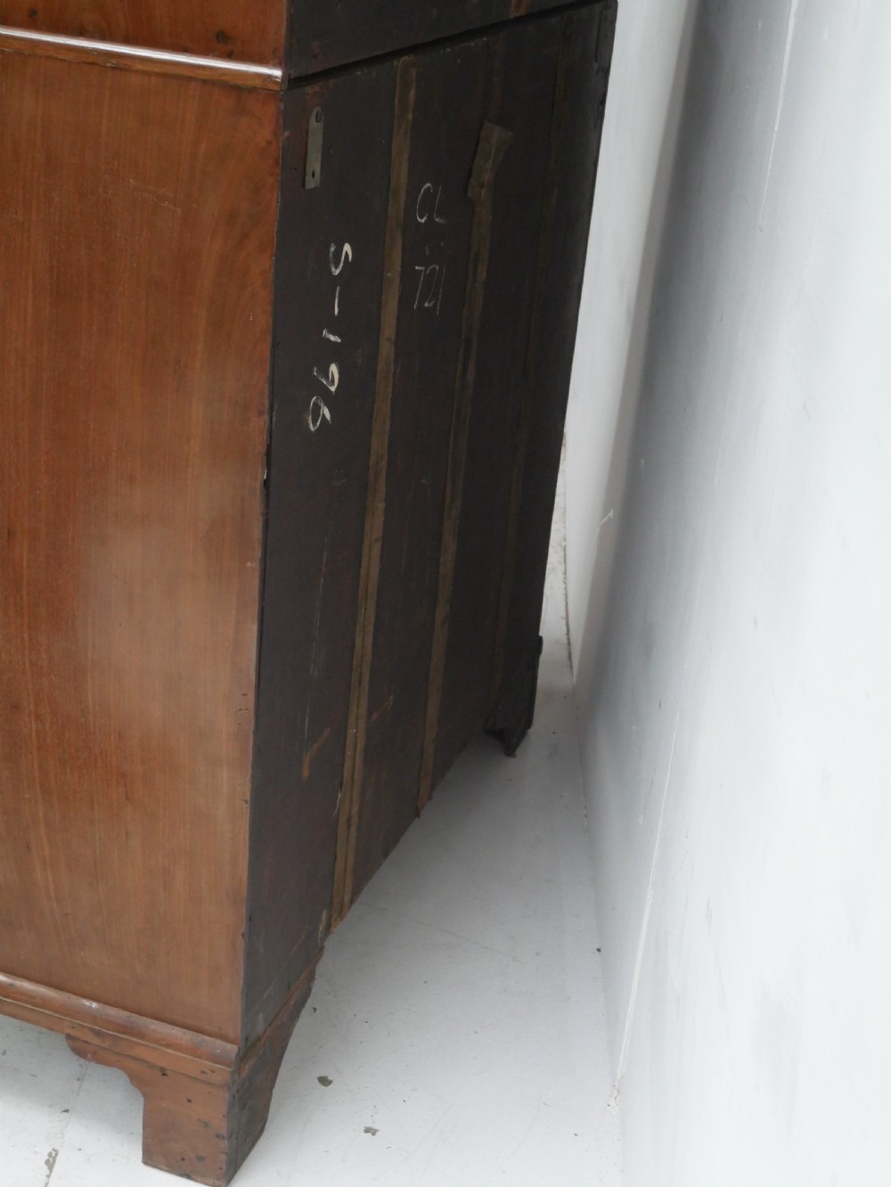 A tall Georgian mahogany bureau bookcase featuring a swan-neck pediment, glazed upper doors, a slant-front writing slope, four long drawers, and bracket feet. View VII