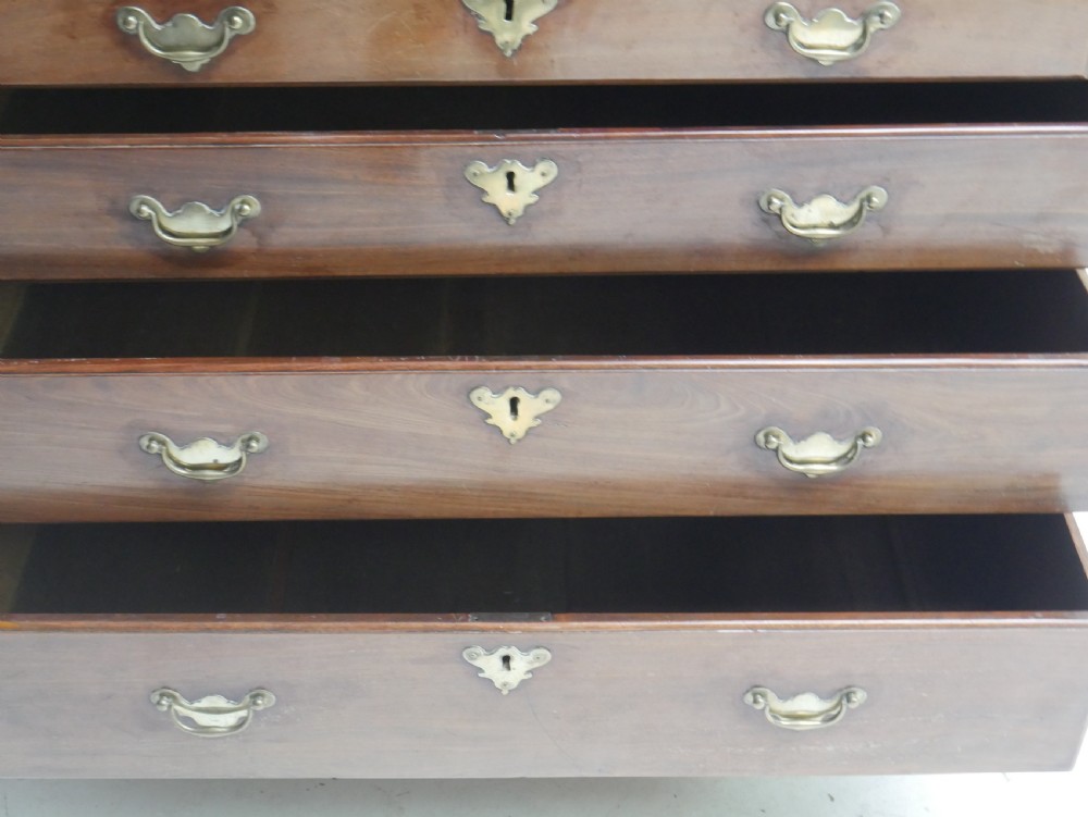 A tall Georgian mahogany bureau bookcase featuring a swan-neck pediment, glazed upper doors, a slant-front writing slope, four long drawers, and bracket feet. View IX