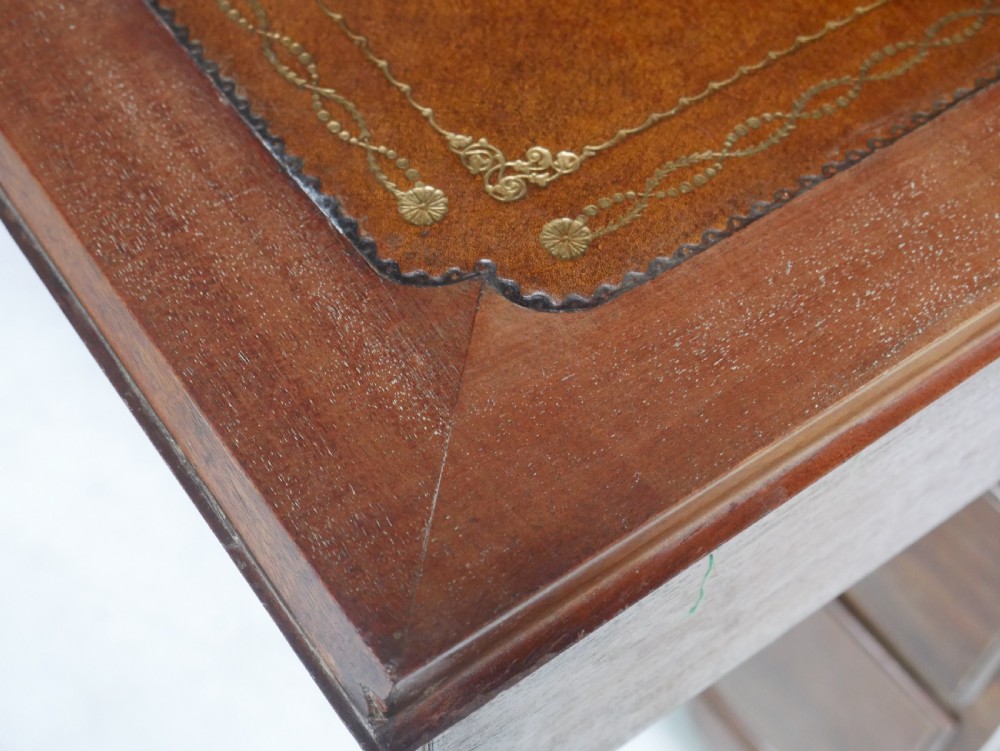 A tall Georgian mahogany bureau bookcase featuring a swan-neck pediment, glazed upper doors, a slant-front writing slope, four long drawers, and bracket feet. View XVII