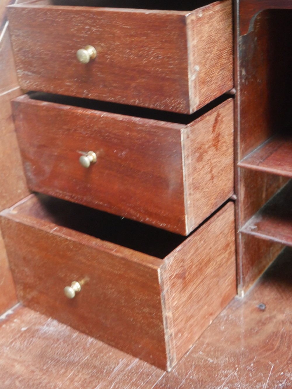 A tall Georgian mahogany bureau bookcase featuring a swan-neck pediment, glazed upper doors, a slant-front writing slope, four long drawers, and bracket feet. View XVIII
