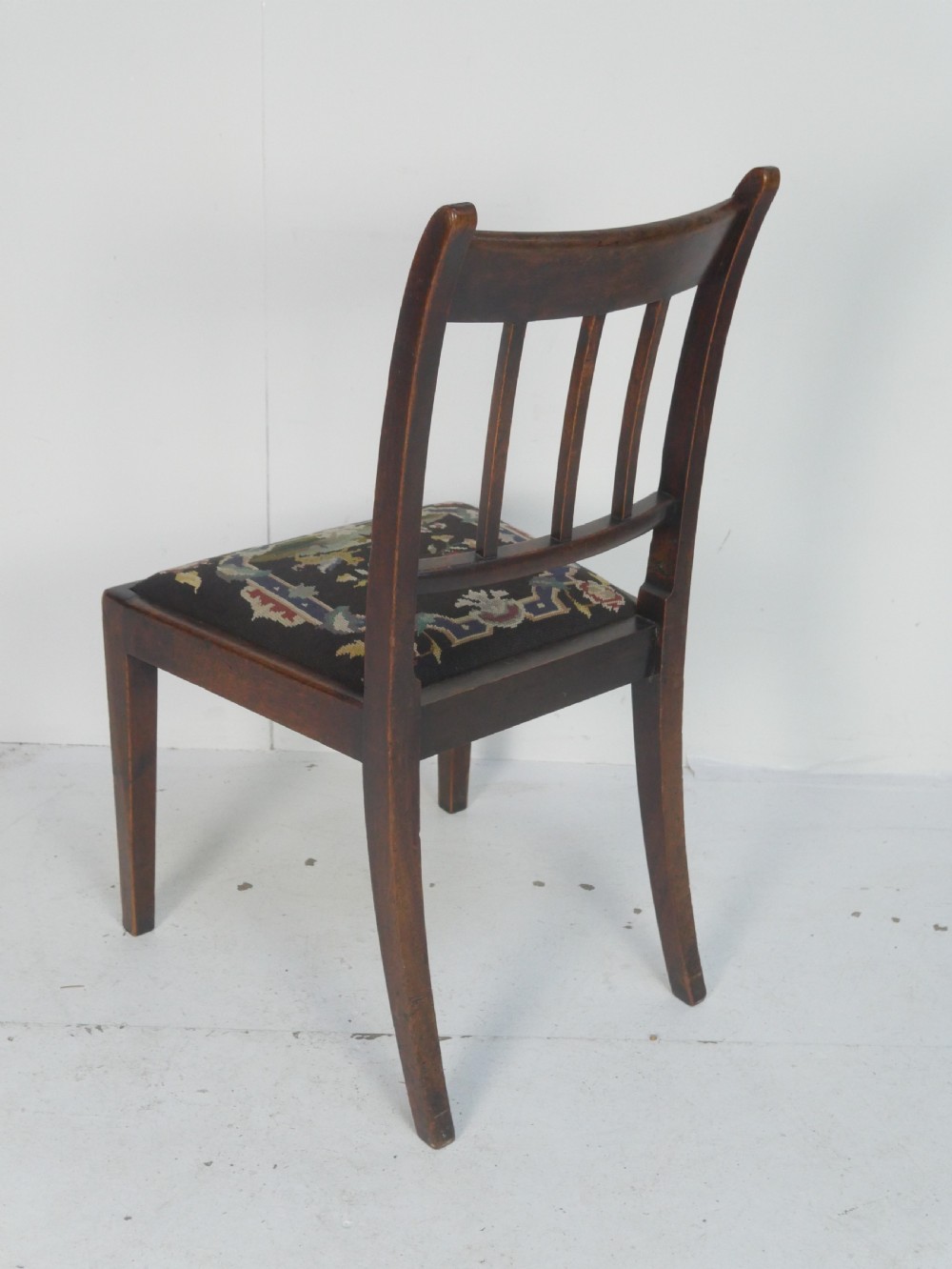 A set of six antique Georgian mahogany dining chairs with reeded vertical bar backs and embroidered needlepoint drop-in seats. View III
