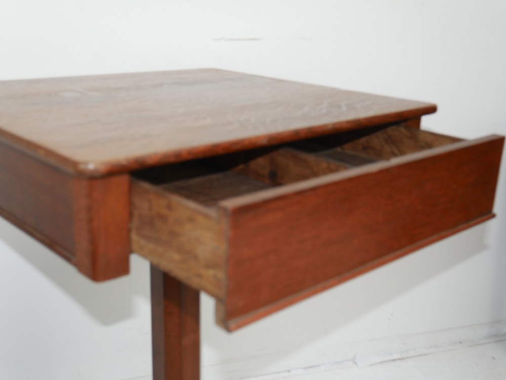 A square-topped antique oak side table featuring a central column support resting on a curved four-legged pedestal base. View V