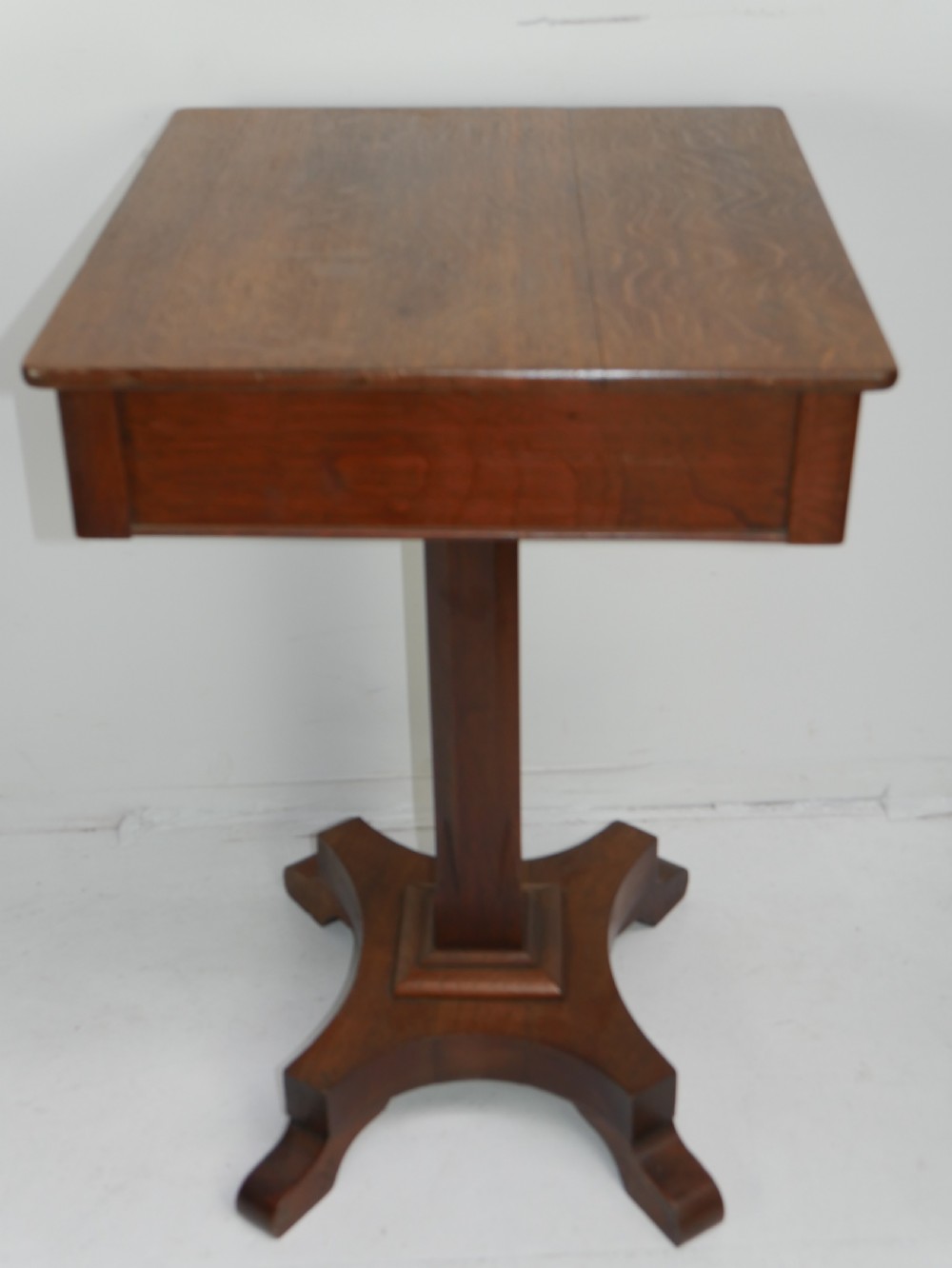 A square-topped antique oak side table featuring a central column support resting on a curved four-legged pedestal base. View VII