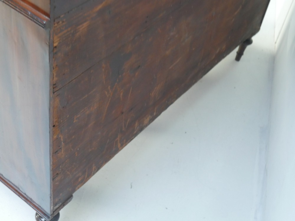 A Georgian mahogany chiffonier featuring an upper display shelf supported by brass columns above panelled cupboard doors and turned legs. View XII
