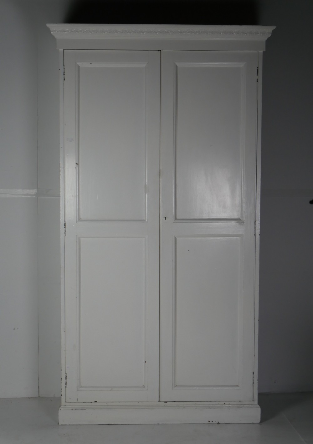 A large double-door white painted wooden wardrobe with open doors revealing a natural pine interior featuring a hanging rail and top shelf. View II