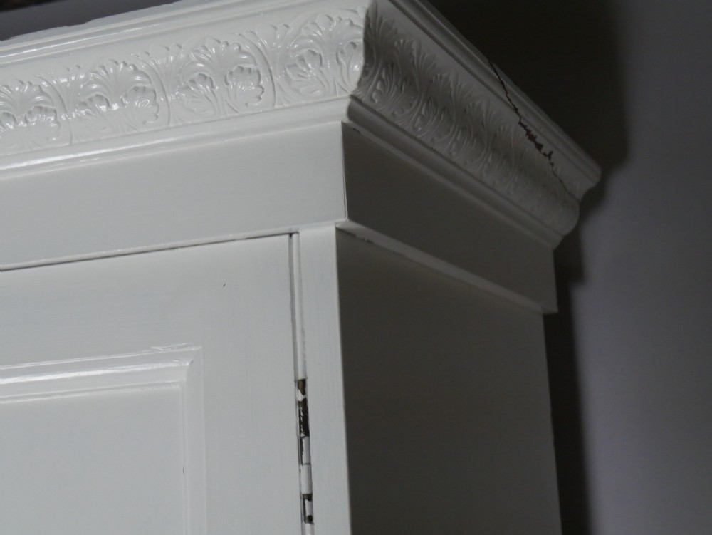 A large double-door white painted wooden wardrobe with open doors revealing a natural pine interior featuring a hanging rail and top shelf. View XI