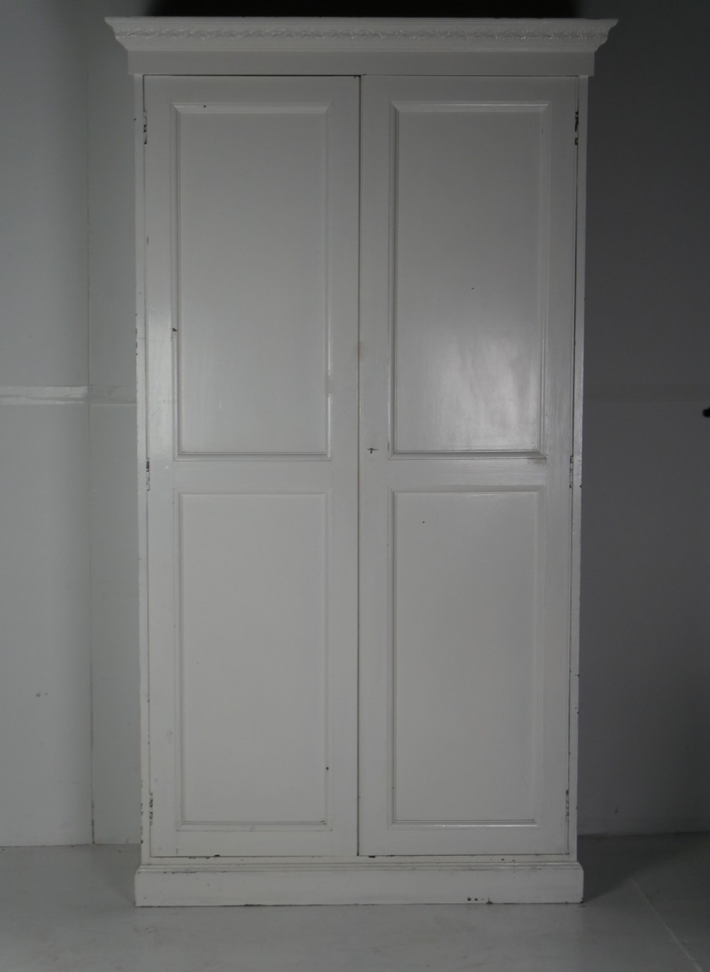A large double-door white painted wooden wardrobe with open doors revealing a natural pine interior featuring a hanging rail and top shelf. View XVI