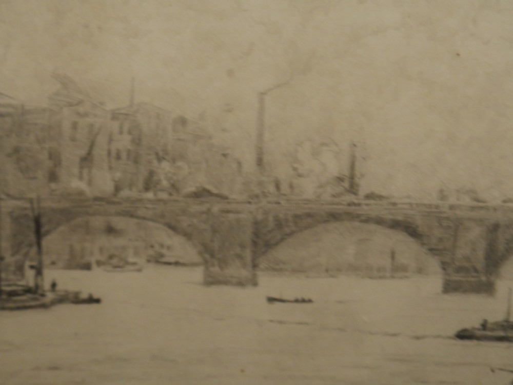 A framed monochrome etching depicting ships and barges on the River Thames with London Bridge in the background. View VII
