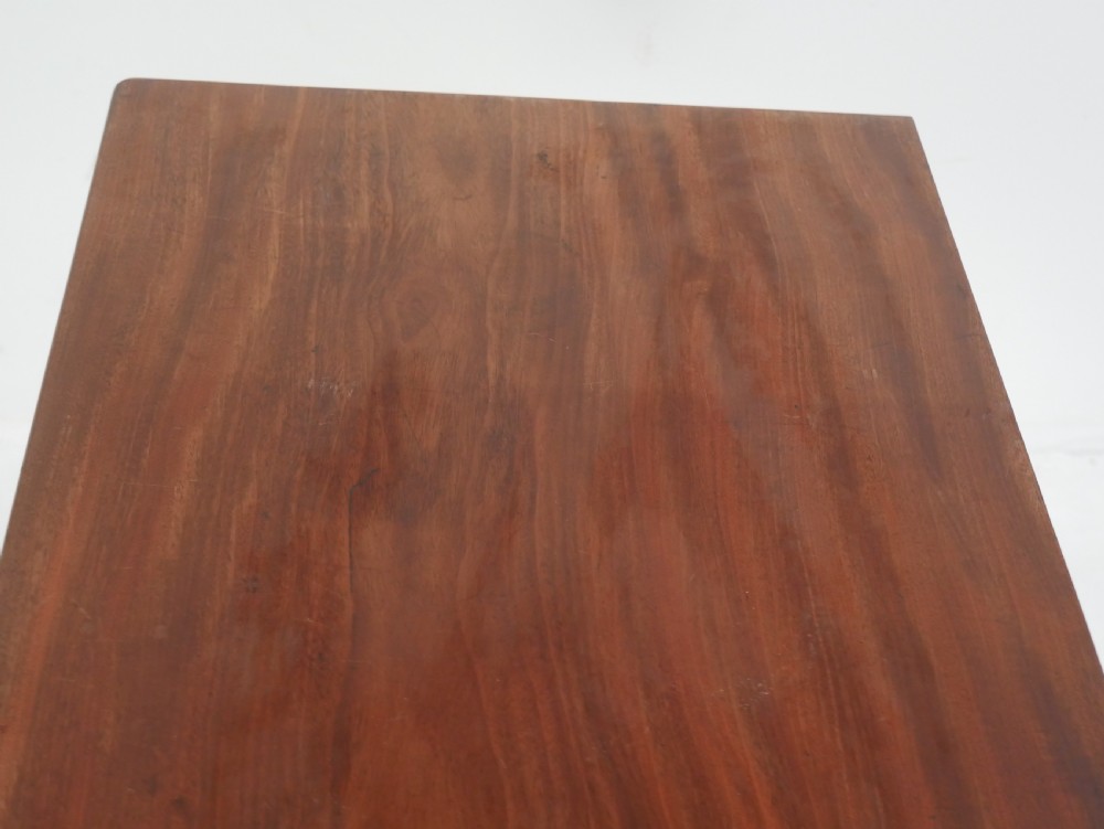 A nineteenth-century mahogany turn-over table with a pedestal stem, carved scroll brackets, and a quadform base on scroll feet. View X