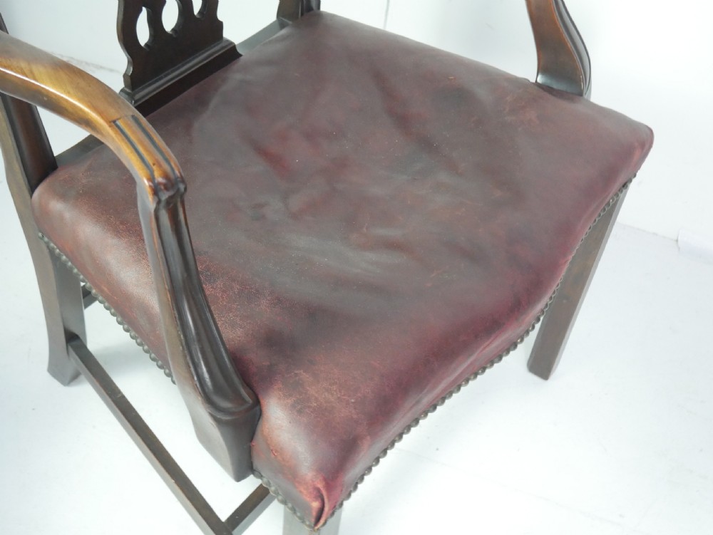 A set of eight mahogany Chippendale style dining chairs featuring pierced splat backs, square legs with stretchers, and burgundy leather seats trimmed with brass studs. View XII