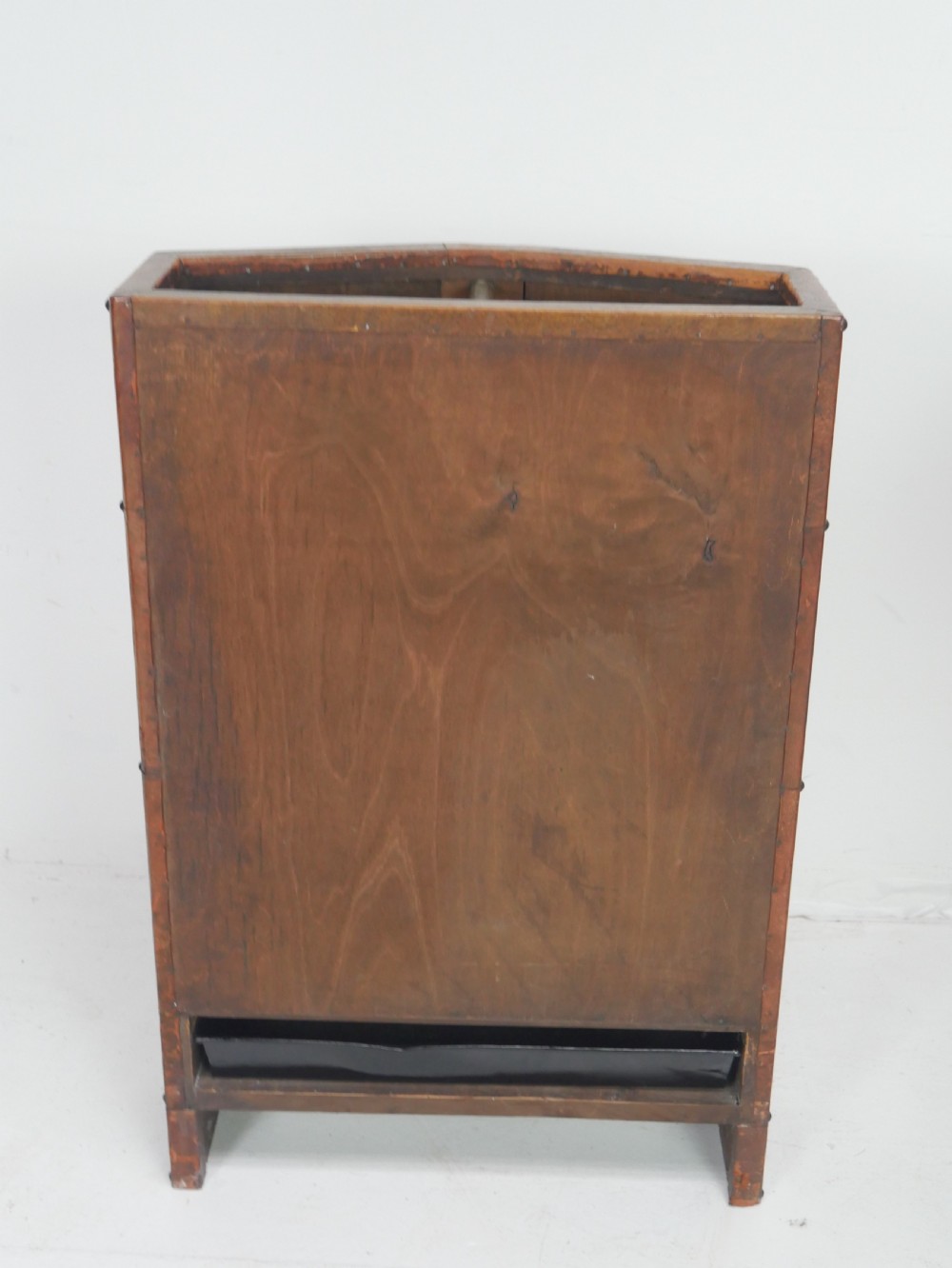 A tall, angular brown leather umbrella stand crafted with studded metal borders and decorative embossed detailing. View VII