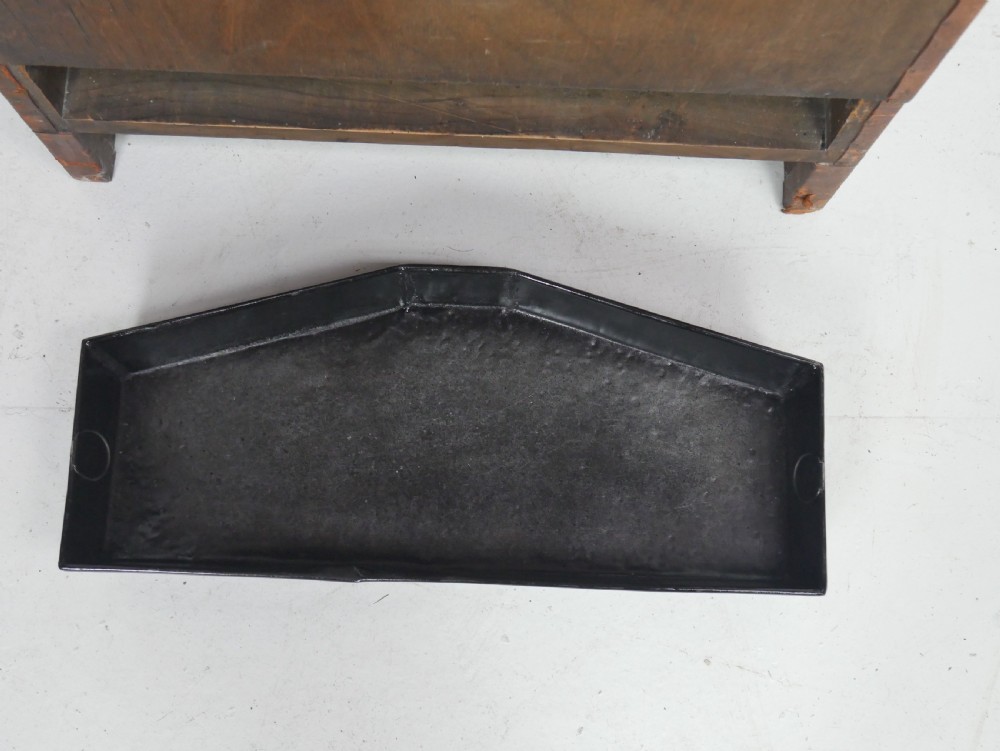 A tall, angular brown leather umbrella stand crafted with studded metal borders and decorative embossed detailing. View X
