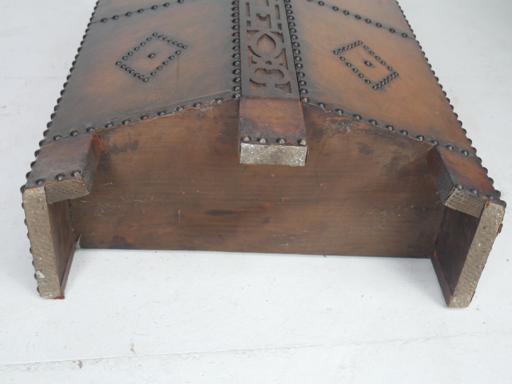 A tall, angular brown leather umbrella stand crafted with studded metal borders and decorative embossed detailing. View XI