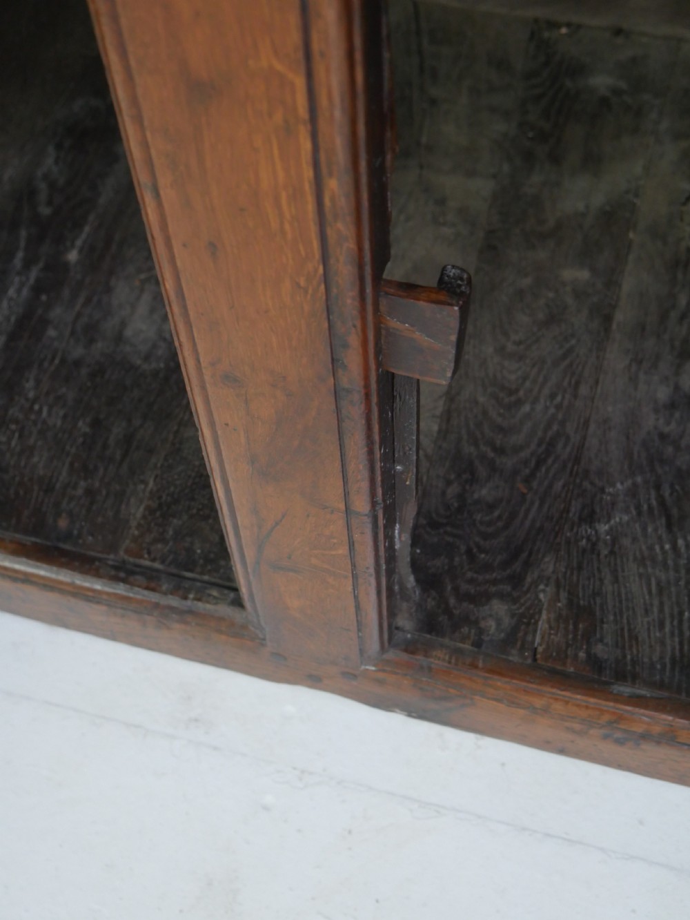 A Georgian oak dresser base featuring two top drawers above two fielded panel cupboard doors fitted with small brass knobs. View IX