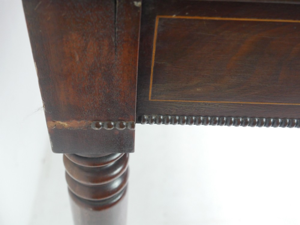 A Regency mahogany fold-over side table with an inlaid decorative frieze and four turned legs. View VI