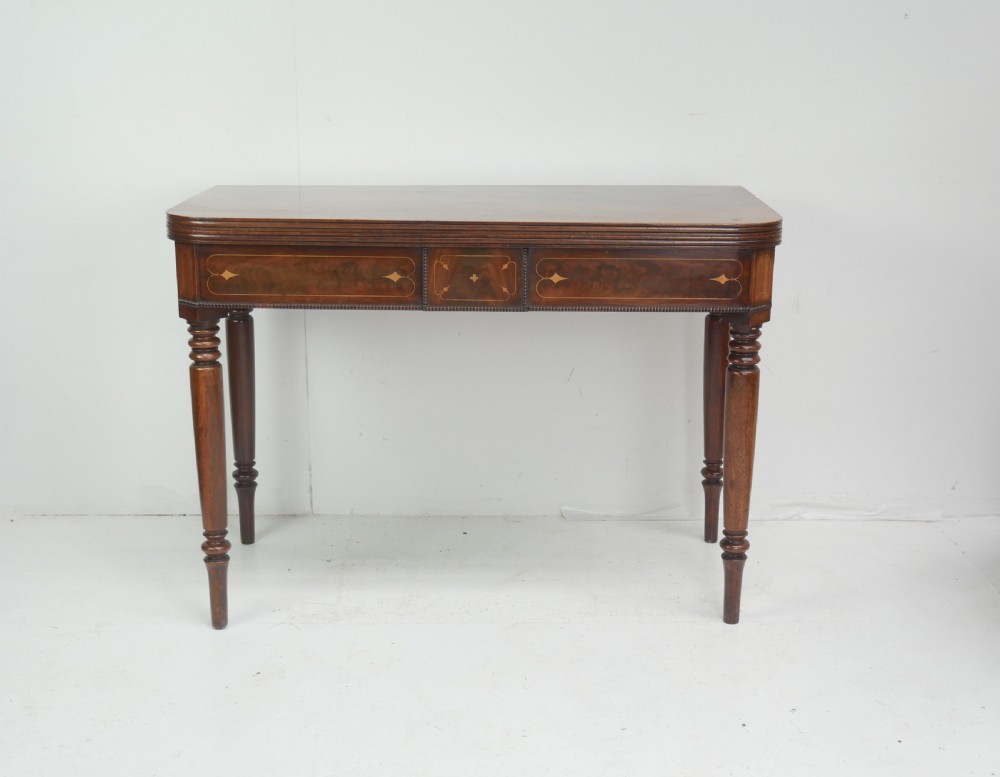A Regency mahogany fold-over side table with an inlaid decorative frieze and four turned legs. View XII