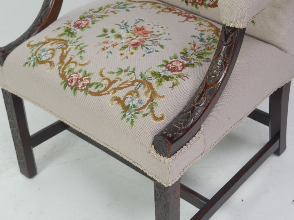A Georgian Gainsborough armchair with dark carved mahogany legs, upholstered in beige needlepoint tapestry featuring a central pastoral scene and floral borders. View III