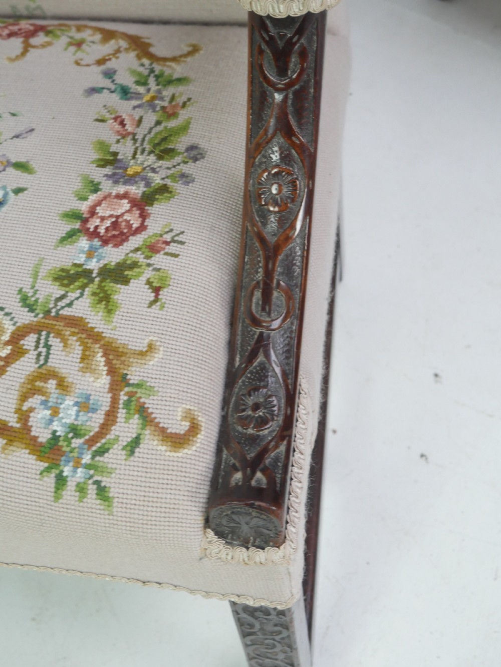 A Georgian Gainsborough armchair with dark carved mahogany legs, upholstered in beige needlepoint tapestry featuring a central pastoral scene and floral borders. View V