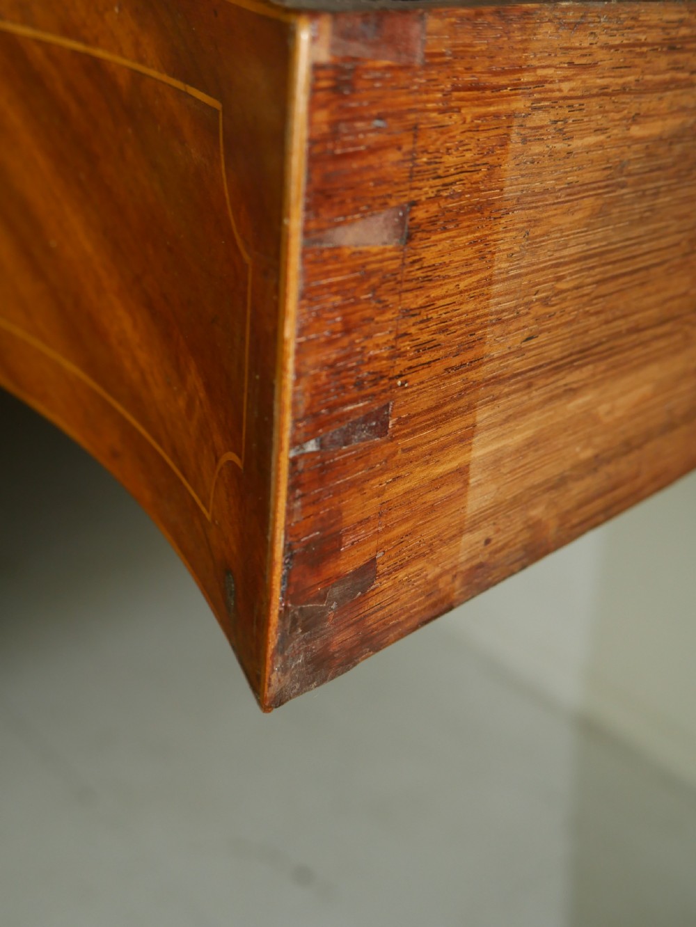 A Scottish Georgian mahogany sideboard featuring a raised stage top superstructure, stringing inlay, three drawer fronts with brass drop handles, and square tapered legs. View VI