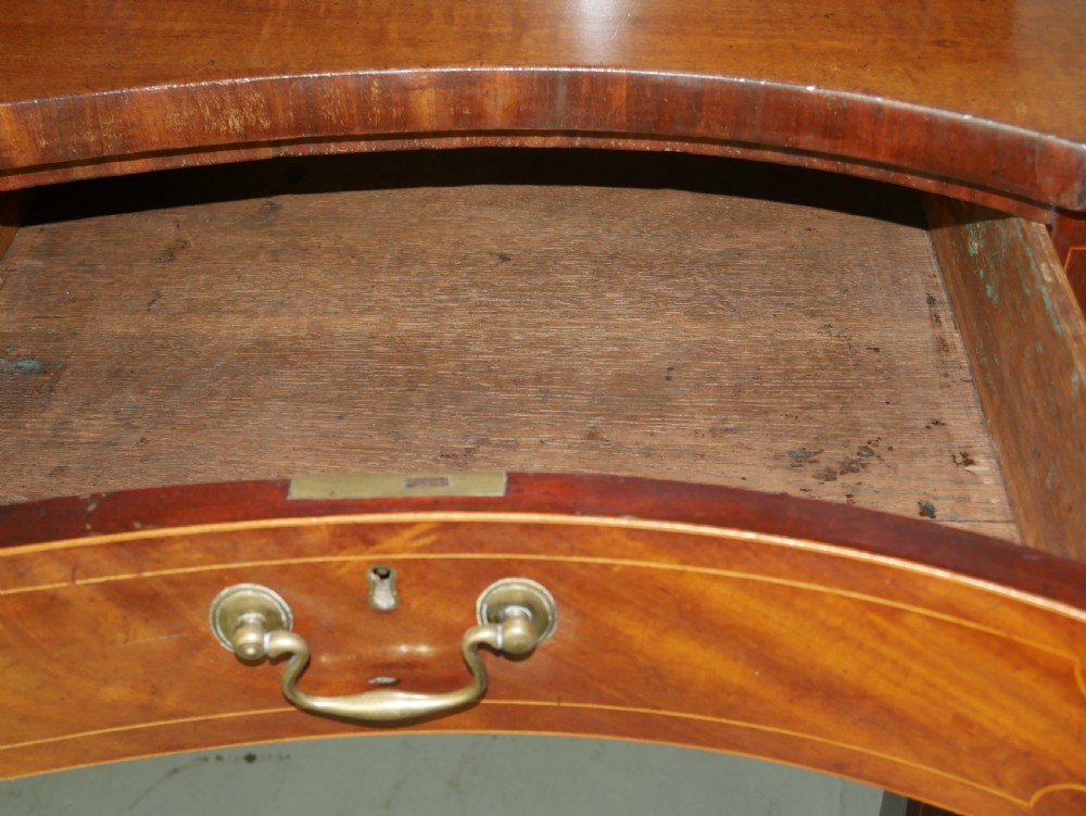A Scottish Georgian mahogany sideboard featuring a raised stage top superstructure, stringing inlay, three drawer fronts with brass drop handles, and square tapered legs. View VII