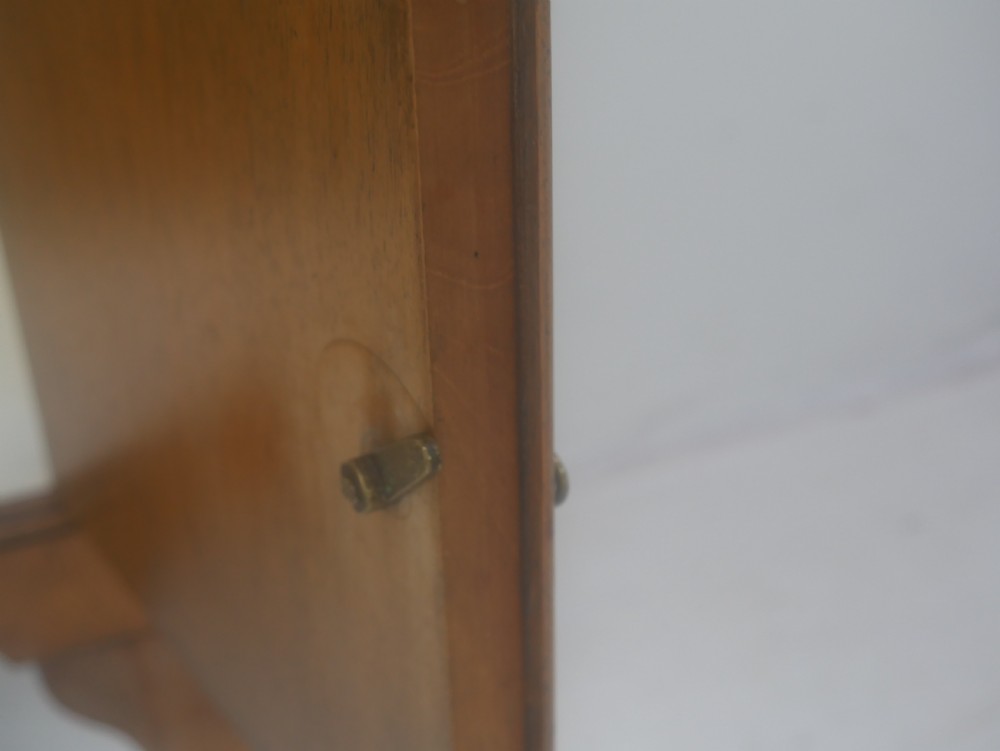 A Queen Anne revival walnut bedside cabinet featuring two top drawers, a two-door cupboard, and tall cabriole legs. View X