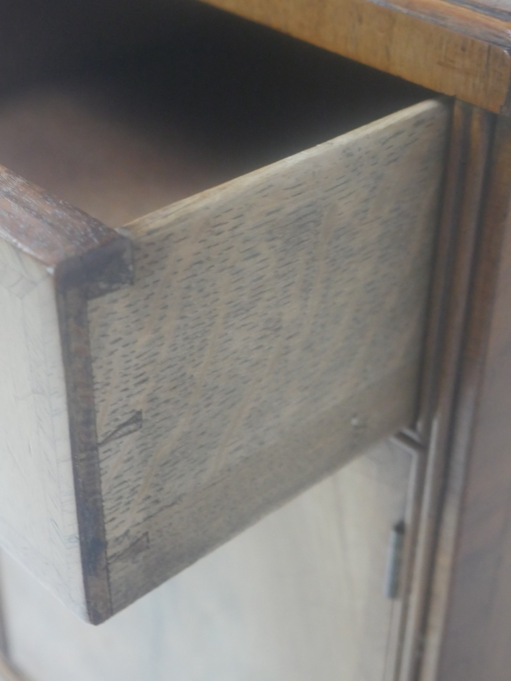 A Queen Anne revival walnut bedside cabinet featuring two top drawers, a two-door cupboard, and tall cabriole legs. View XVI