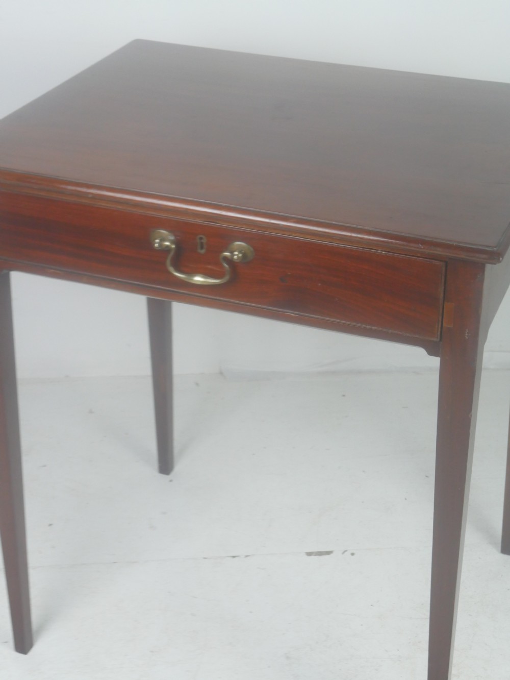 A rectangular mahogany lamp table with straight tapered legs and a single drawer featuring a brass drop handle. View III