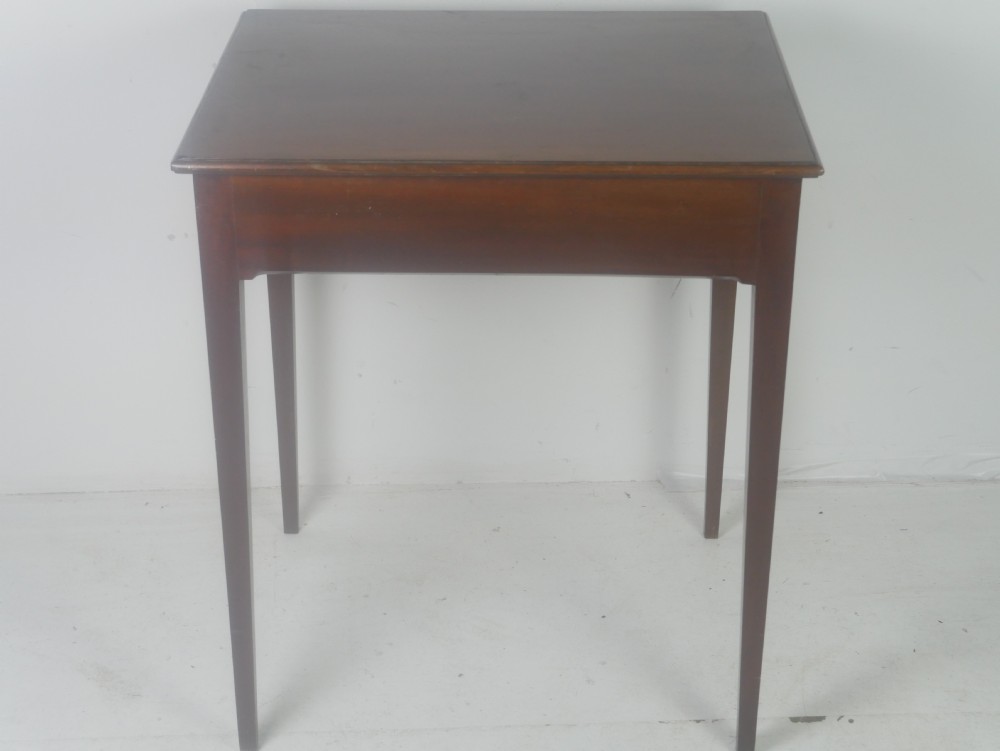 A rectangular mahogany lamp table with straight tapered legs and a single drawer featuring a brass drop handle. View VII