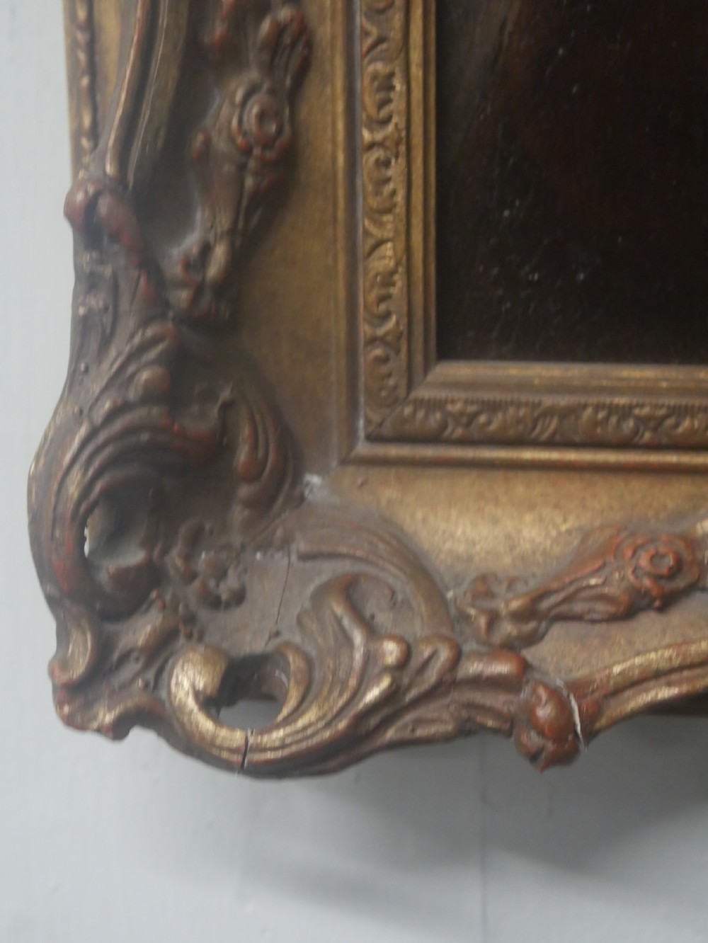 An oil portrait on canvas depicting a male Northumbrian piper holding smallpipes, housed in an ornate carved gilt frame. View IV