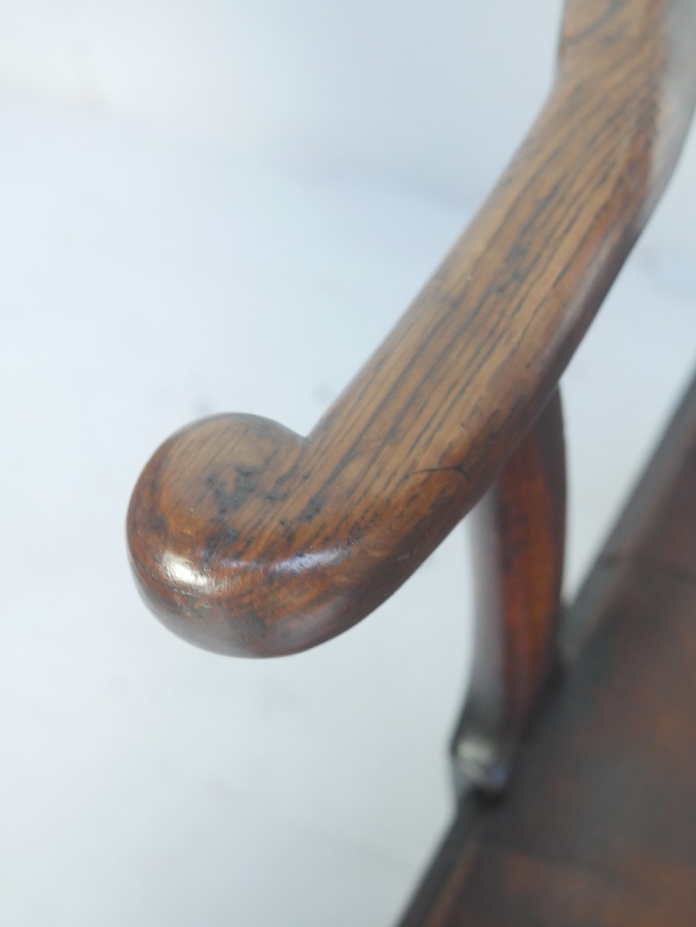 A dark wood Georgian country armchair featuring a pierced back splat with a heart motif, solid seat, curved armrests, and a sturdy stretcher base. View III