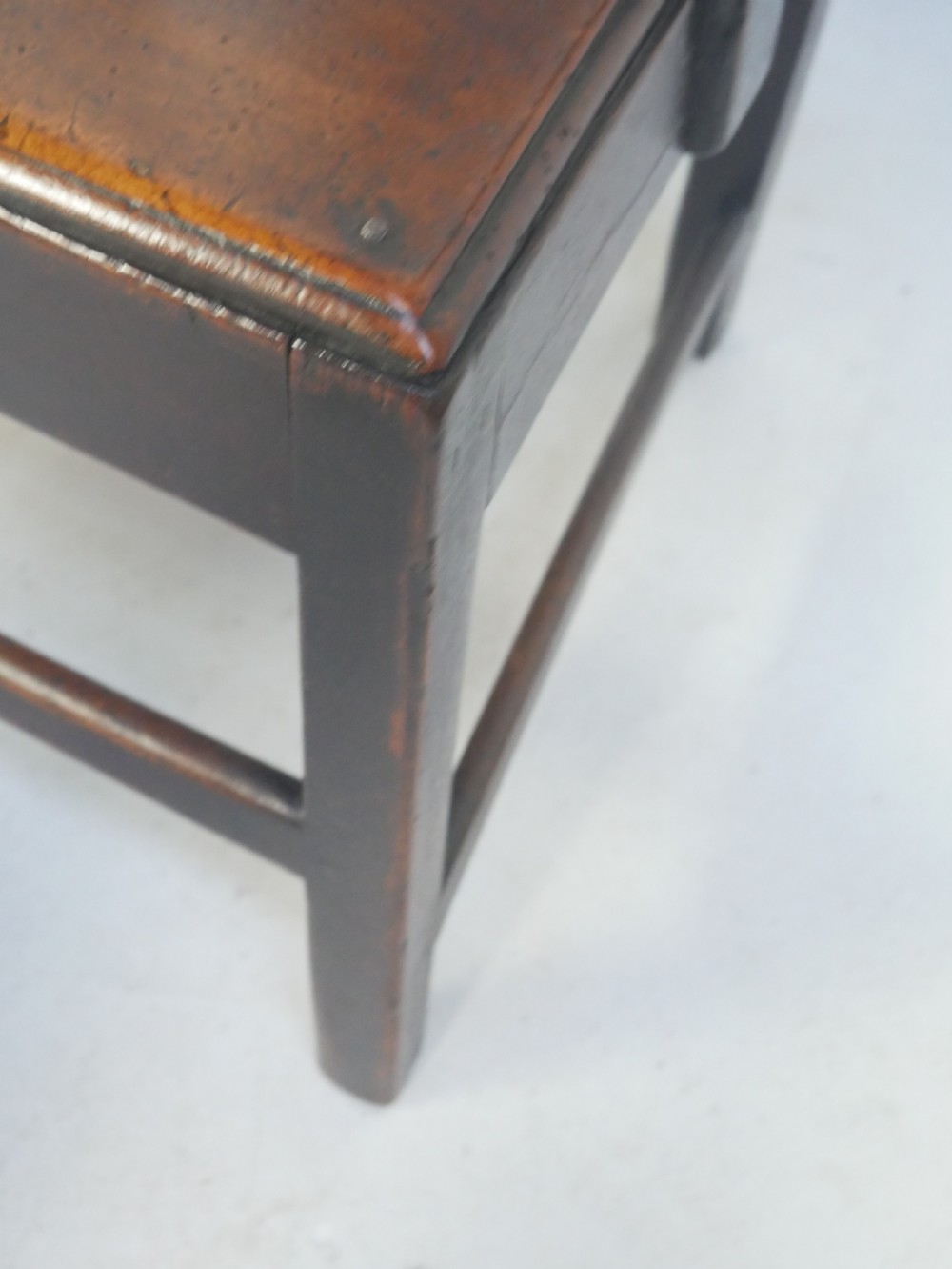 A dark wood Georgian country armchair featuring a pierced back splat with a heart motif, solid seat, curved armrests, and a sturdy stretcher base. View VI