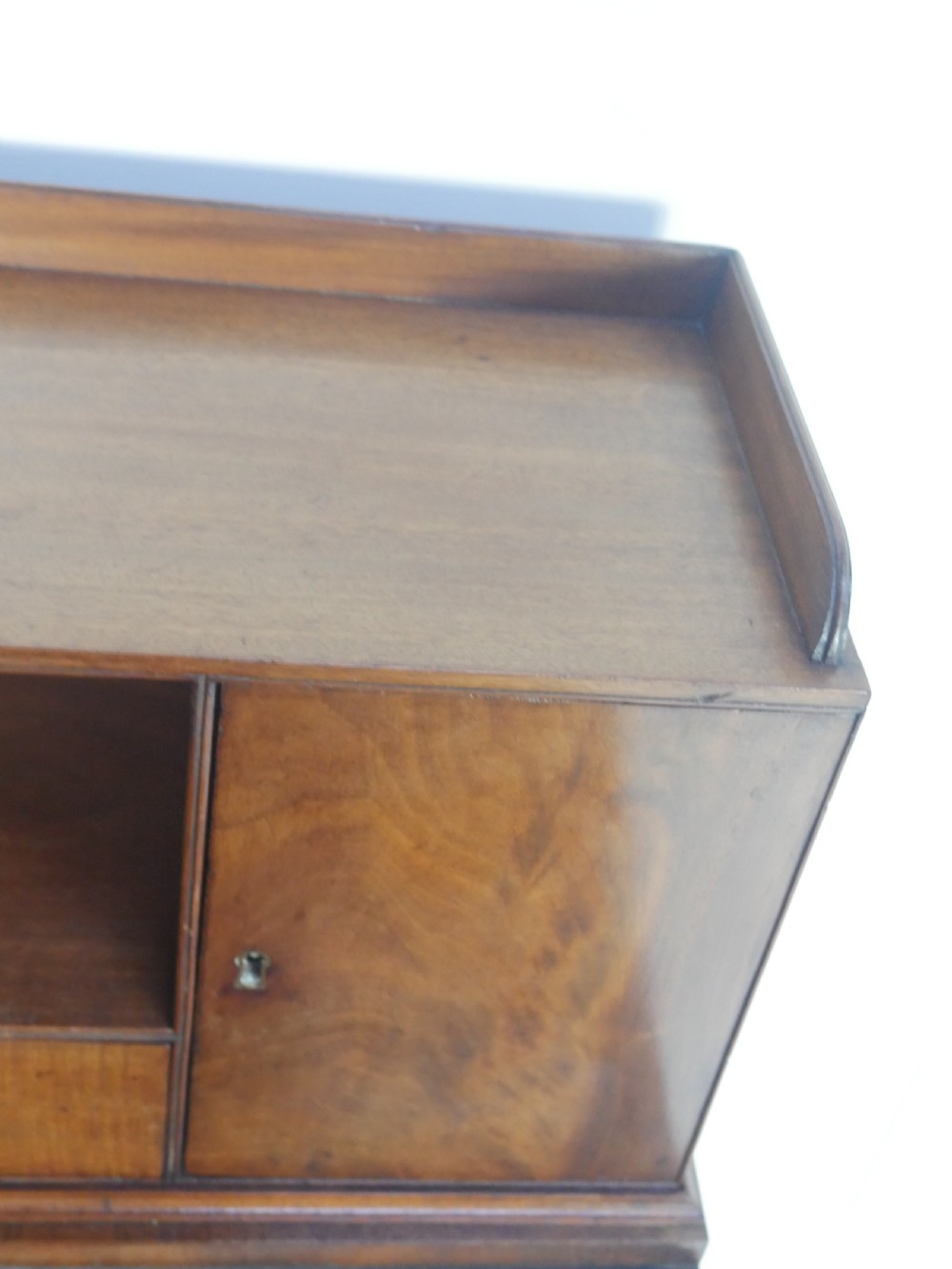 A mahogany bonheur de jour writing desk featuring a raised rear cabinet with two small doors and a central niche above a single frieze drawer on square tapered legs. View IV