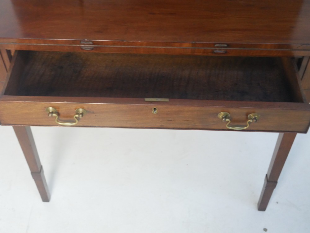 A mahogany bonheur de jour writing desk featuring a raised rear cabinet with two small doors and a central niche above a single frieze drawer on square tapered legs. View V