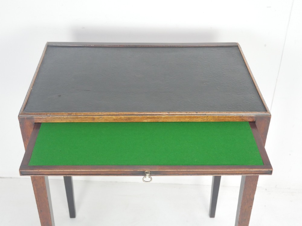 A Georgian mahogany side table featuring a dark leather inset top, frieze drawer with brass handles, and slender tapered legs. View III