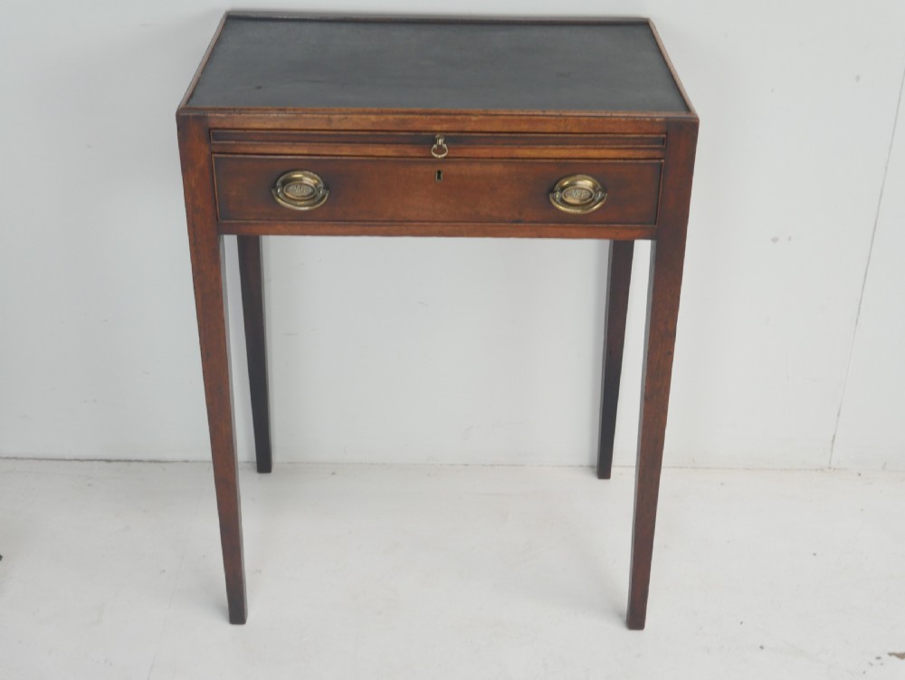 A Georgian mahogany side table featuring a dark leather inset top, frieze drawer with brass handles, and slender tapered legs. View XII