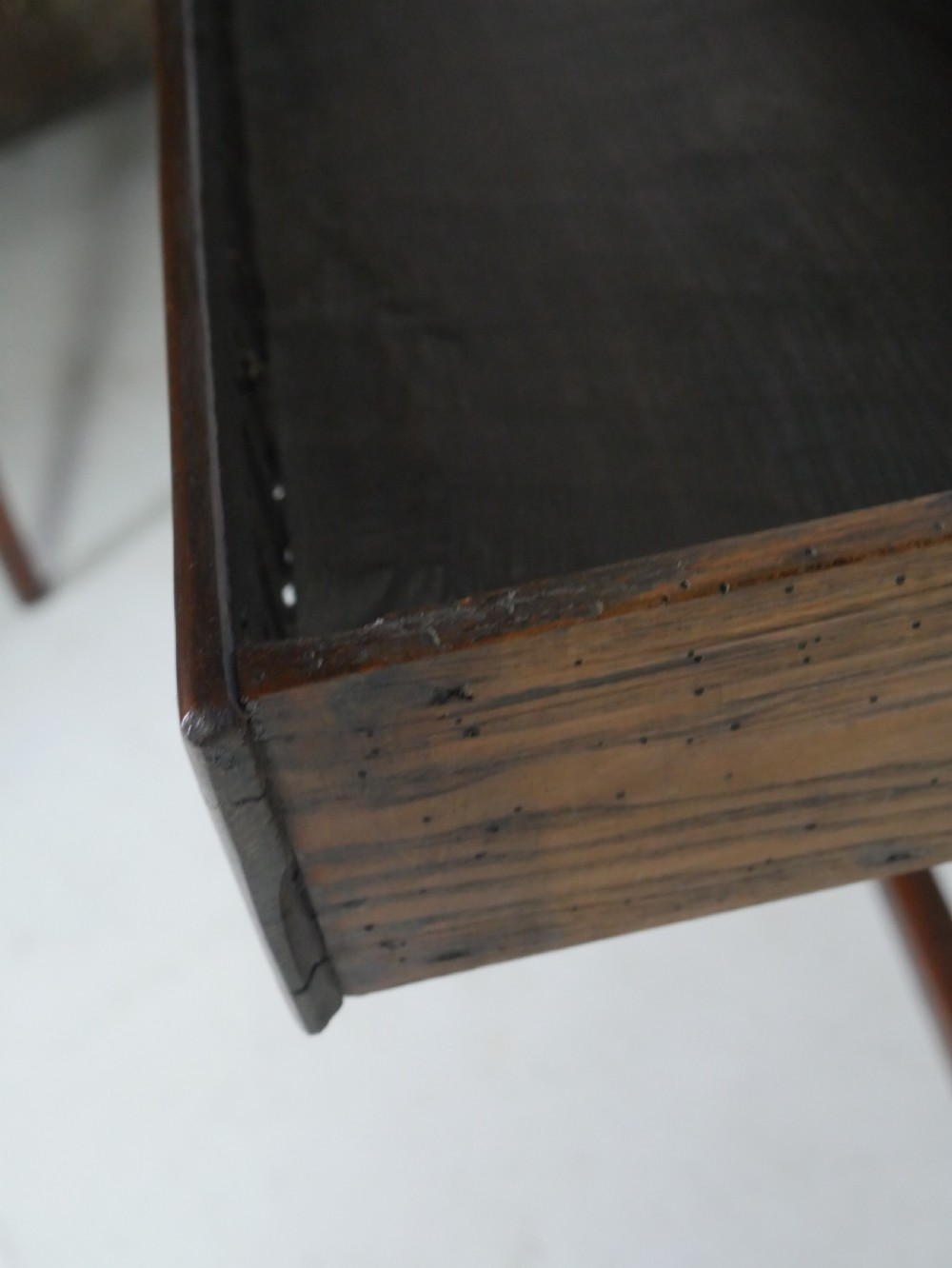 A dark brown Georgian oak side table featuring a single drawer with brass drop handles, turned legs, and a sturdy lower perimeter stretcher. View IV