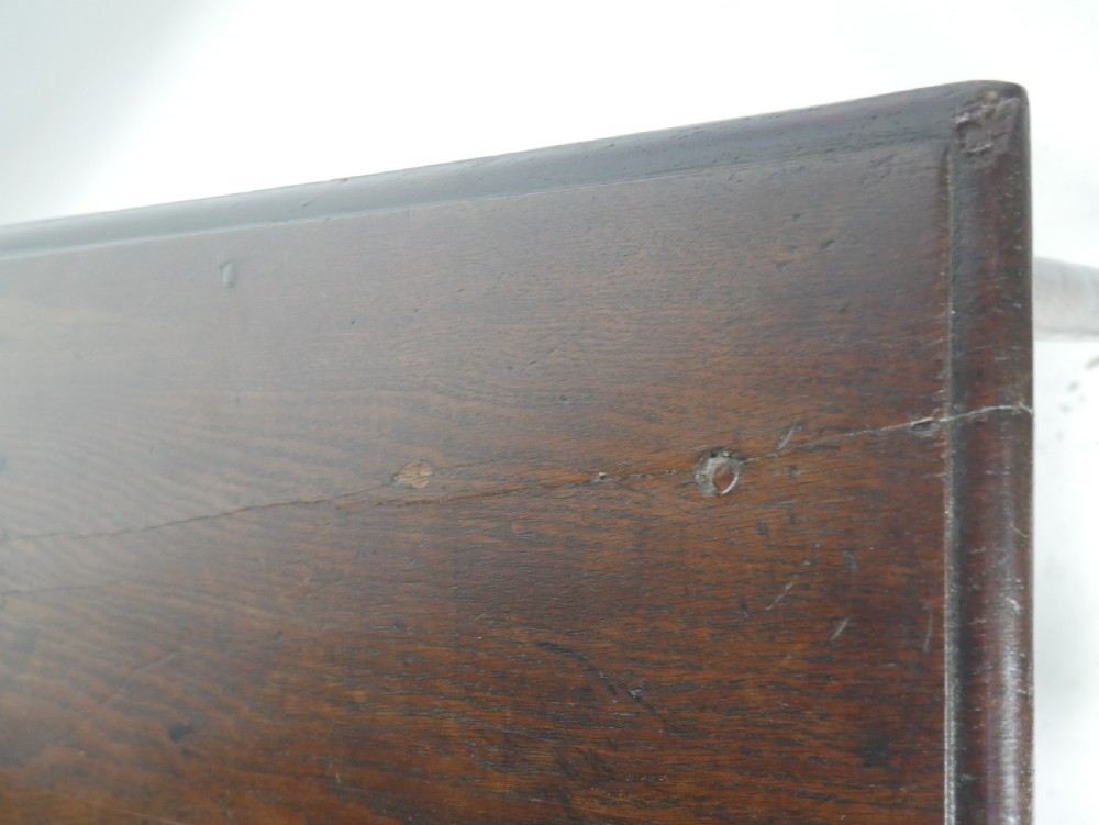 A dark brown Georgian oak side table featuring a single drawer with brass drop handles, turned legs, and a sturdy lower perimeter stretcher. View VIII