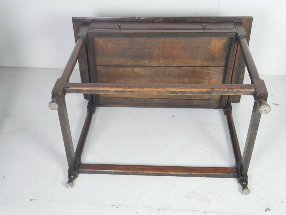 A dark brown Georgian oak side table featuring a single drawer with brass drop handles, turned legs, and a sturdy lower perimeter stretcher. View XIII