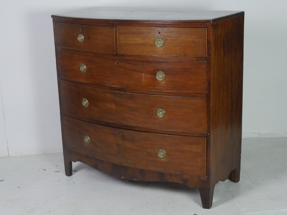 A Georgian mahogany bow-front chest of drawers featuring two short drawers over three long graduated drawers with circular brass drop handles. View XIII