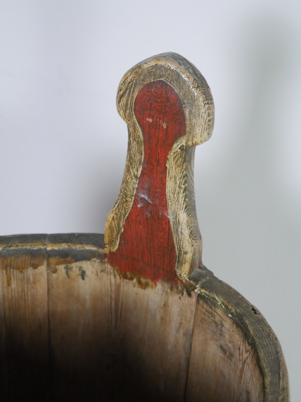 A tall, cylindrical red-painted wooden umbrella stand featuring hand-painted floral motifs and raised wooden banding. View VI